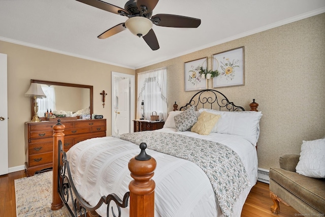 bedroom with wood-type flooring, ceiling fan, and ornamental molding