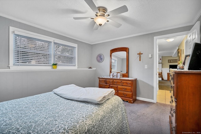 carpeted bedroom featuring ceiling fan, wooden walls, a textured ceiling, and ornamental molding