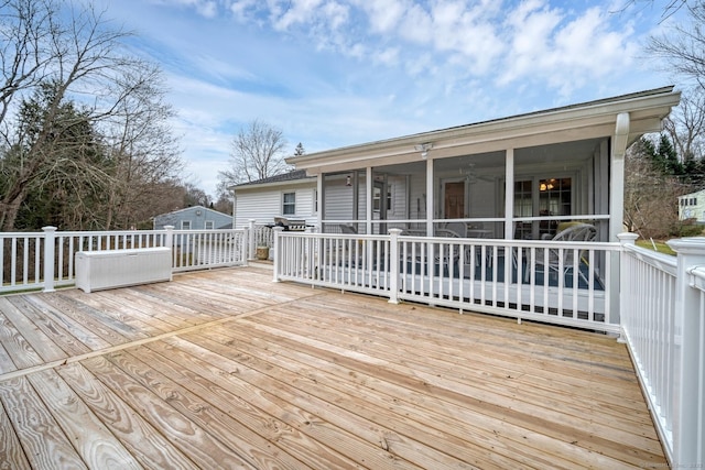 wooden deck with a sunroom