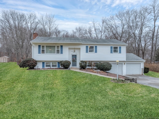 raised ranch with a garage and a front lawn