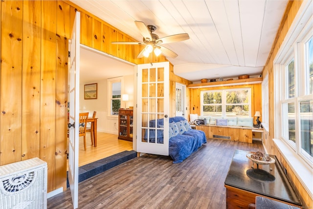 sunroom featuring wooden ceiling, ceiling fan, and vaulted ceiling