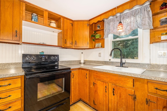 kitchen featuring sink, decorative light fixtures, light hardwood / wood-style floors, and black electric range oven