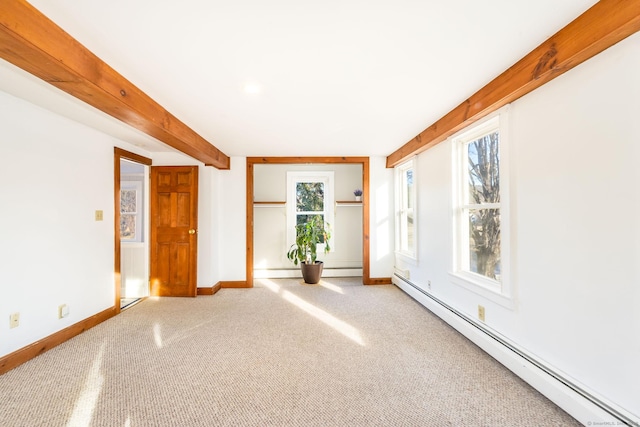 spare room with plenty of natural light, a baseboard radiator, and carpet