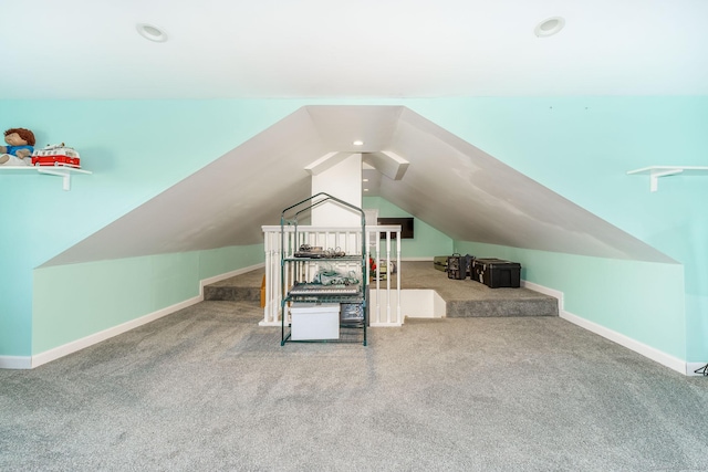 bonus room with vaulted ceiling and carpet