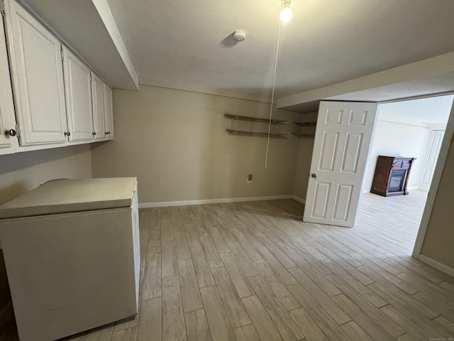 clothes washing area featuring light wood-type flooring