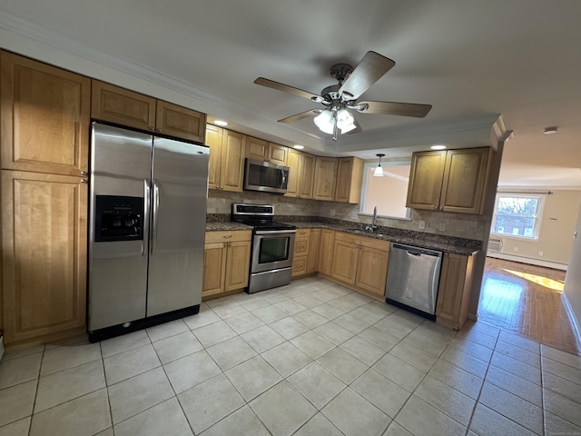 kitchen with ceiling fan, sink, stainless steel appliances, tasteful backsplash, and crown molding