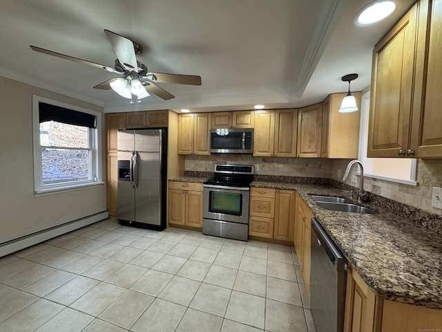 kitchen with ceiling fan, sink, hanging light fixtures, stainless steel appliances, and ornamental molding