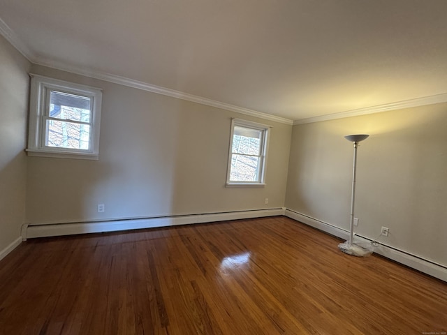 spare room featuring wood-type flooring, ornamental molding, and a baseboard radiator