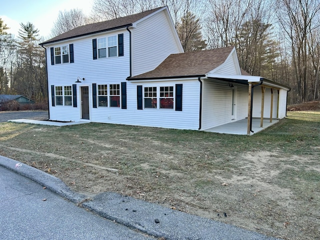 view of front of property with a front yard and a patio