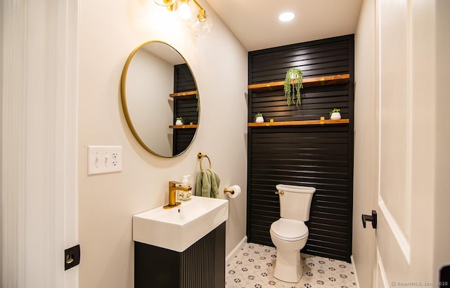 bathroom featuring toilet and vanity