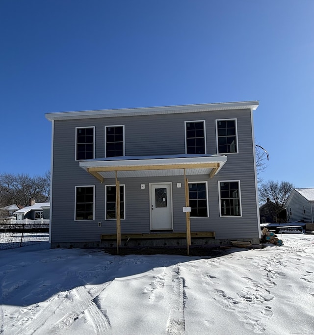 view of front of home with fence and a porch