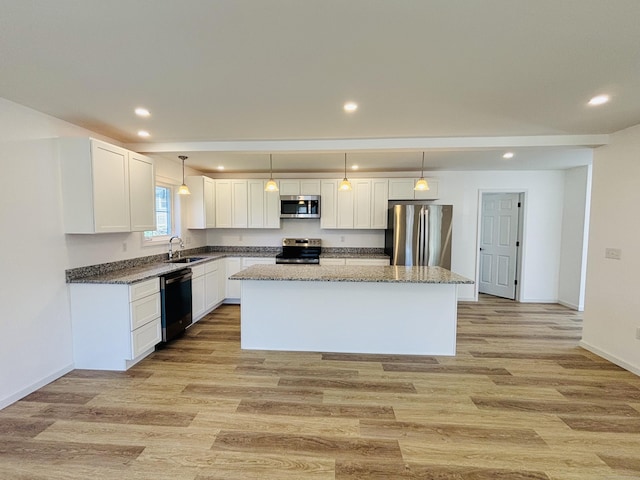 16 Red Bridge Rd, Thompson, CT 06255 - kitchen with stainless steel appliances, a center island, white cabinets, a sink, and light wood-style flooring