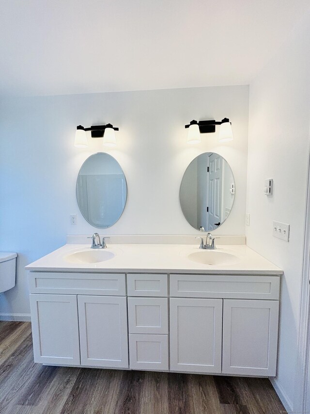 16 Red Bridge Rd, Thompson, CT 06255 - full bathroom with double vanity, wood finished floors, and toilet