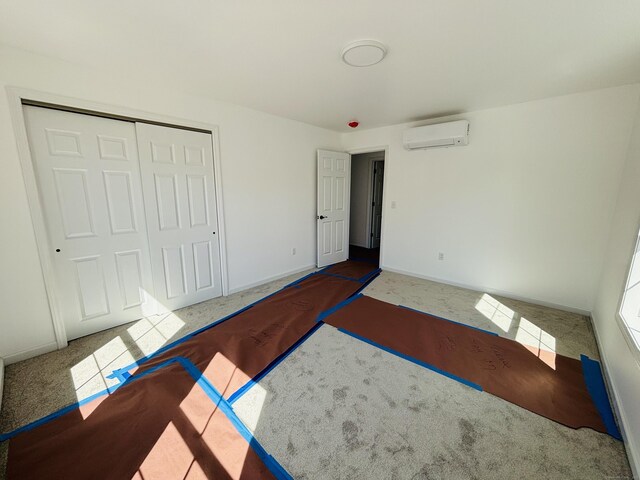 16 Red Bridge Rd, Thompson, CT 06255 - unfurnished bedroom featuring a wall mounted AC, carpet floors, baseboards, and a closet