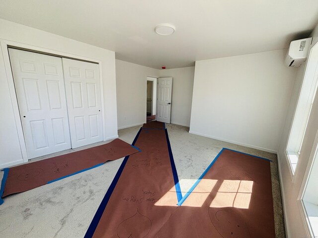 16 Red Bridge Rd, Thompson, CT 06255 - unfurnished bedroom with a wall unit AC, a closet, carpet, and baseboards