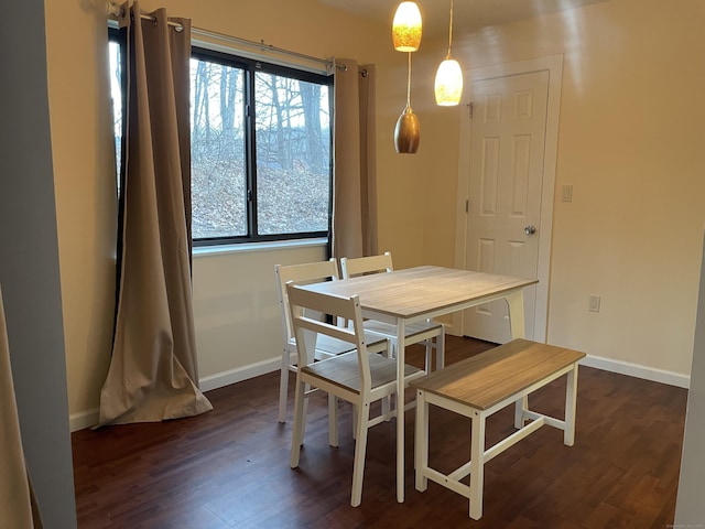 dining area featuring dark hardwood / wood-style flooring and a healthy amount of sunlight