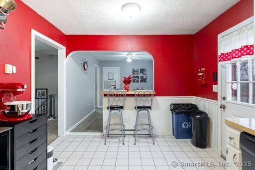 kitchen featuring dishwasher, a textured ceiling, and ceiling fan