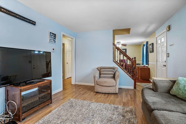 living room featuring hardwood / wood-style flooring and ceiling fan