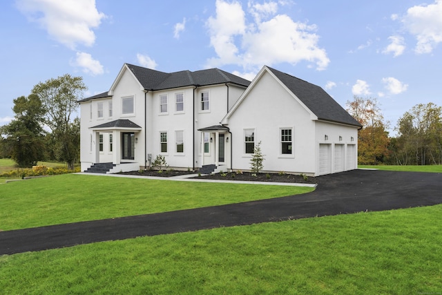 view of front of house featuring a front lawn and a garage