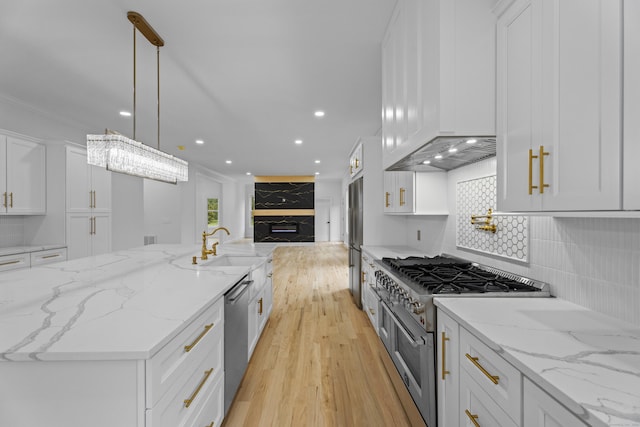 kitchen featuring decorative backsplash, light stone countertops, stainless steel appliances, pendant lighting, and white cabinets