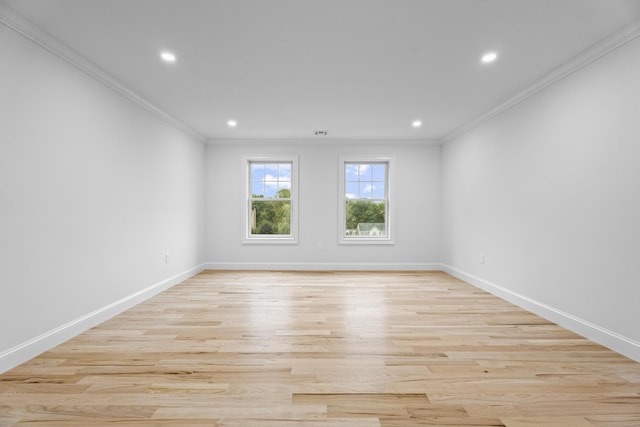 spare room with ornamental molding and light hardwood / wood-style flooring