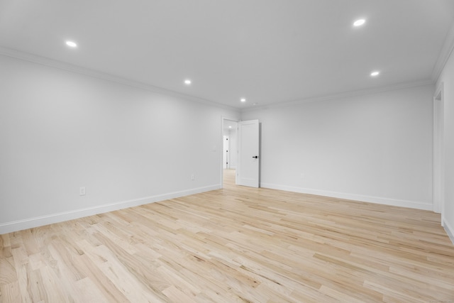 spare room featuring light hardwood / wood-style flooring and ornamental molding