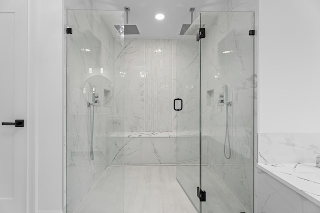 bathroom featuring a shower with shower door