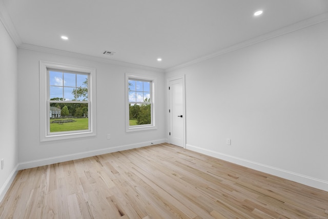 unfurnished room with light hardwood / wood-style flooring and crown molding