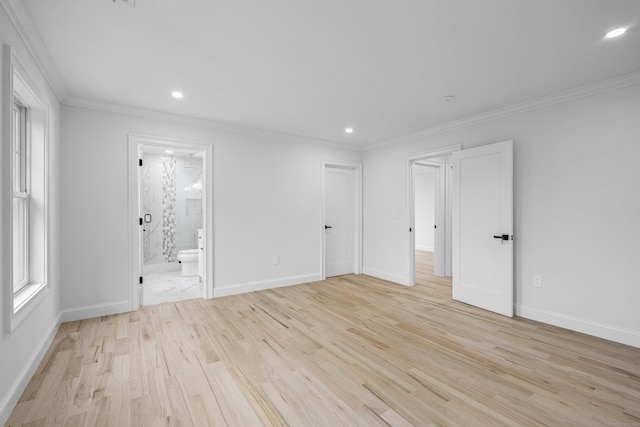 empty room with crown molding and light hardwood / wood-style flooring