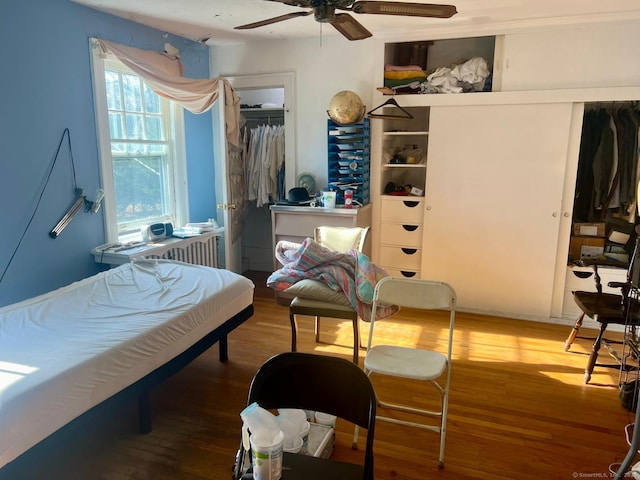 bedroom with a closet, hardwood / wood-style flooring, and ceiling fan