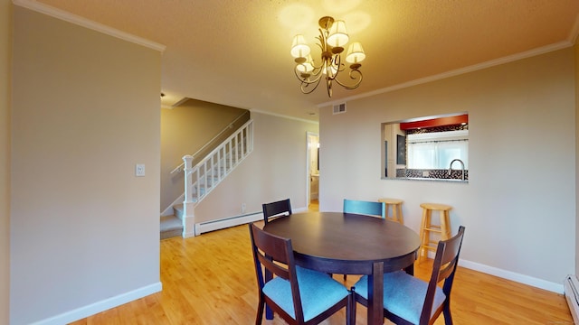 dining room with a chandelier, light hardwood / wood-style floors, and crown molding