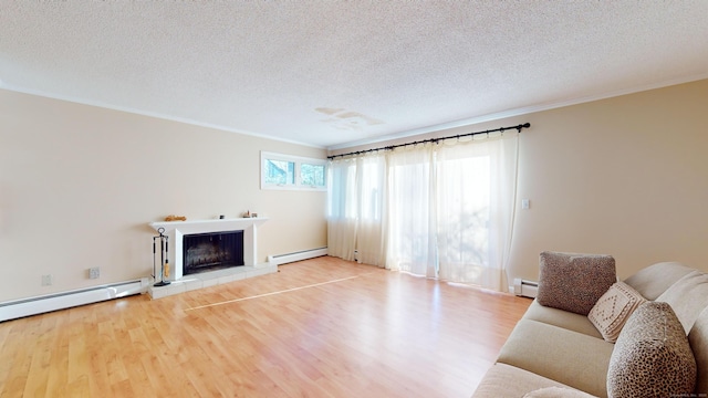 unfurnished living room featuring hardwood / wood-style flooring, a tile fireplace, and a baseboard heating unit