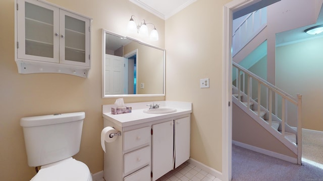 bathroom with vanity, toilet, and crown molding