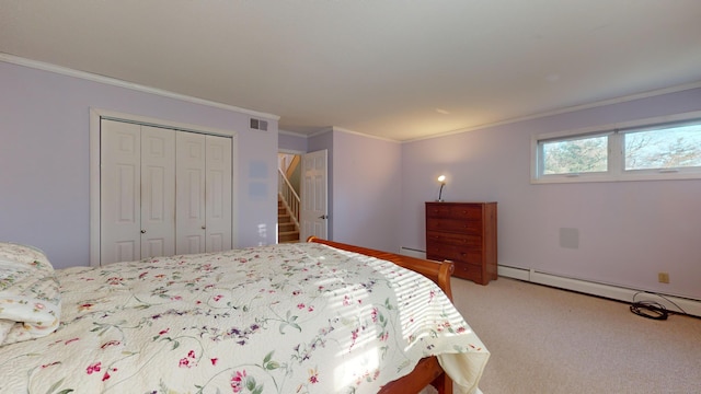 carpeted bedroom featuring a baseboard heating unit, a closet, and crown molding