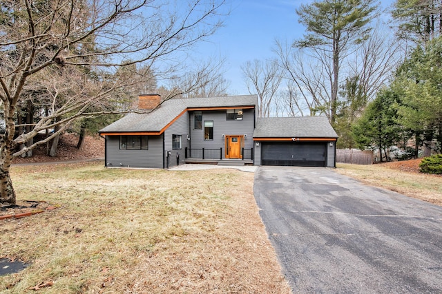 view of front of home with a garage and a front lawn