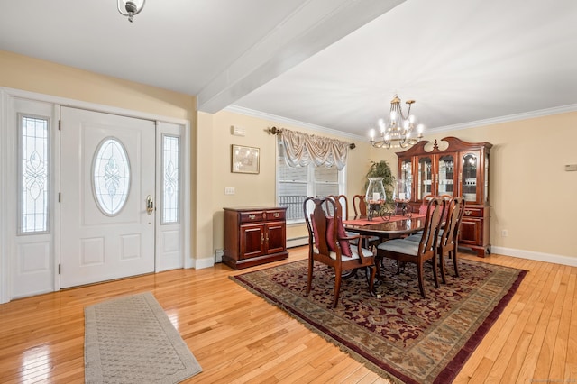 dining space with crown molding, plenty of natural light, a chandelier, and light hardwood / wood-style floors