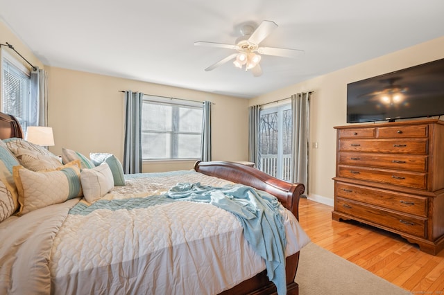 bedroom with access to outside, light hardwood / wood-style floors, and ceiling fan