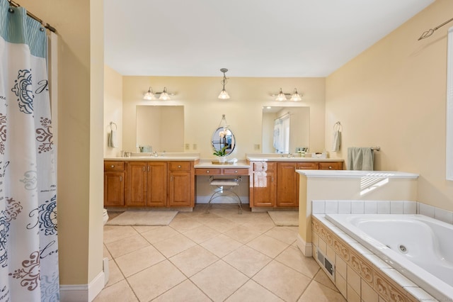 bathroom featuring tile patterned flooring, vanity, and tiled tub