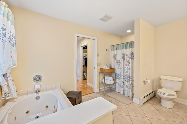 bathroom with toilet, a tub to relax in, a baseboard radiator, and tile patterned floors