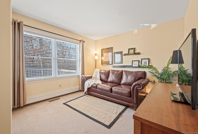 living room with light colored carpet and a baseboard heating unit