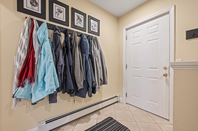 mudroom featuring light tile patterned flooring and a baseboard radiator