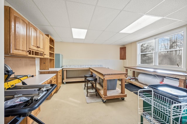 interior space with a workshop area and a drop ceiling