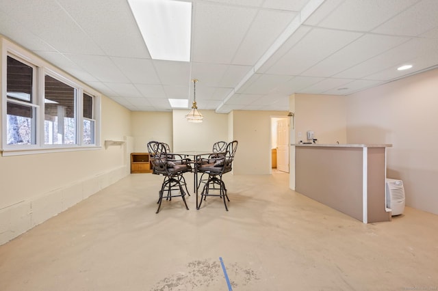 dining space with a paneled ceiling