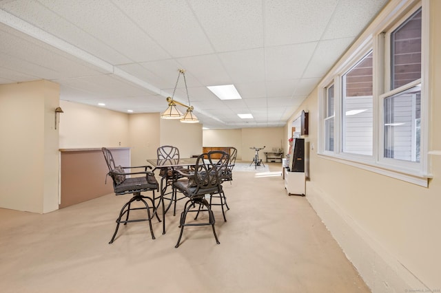 dining space featuring a drop ceiling