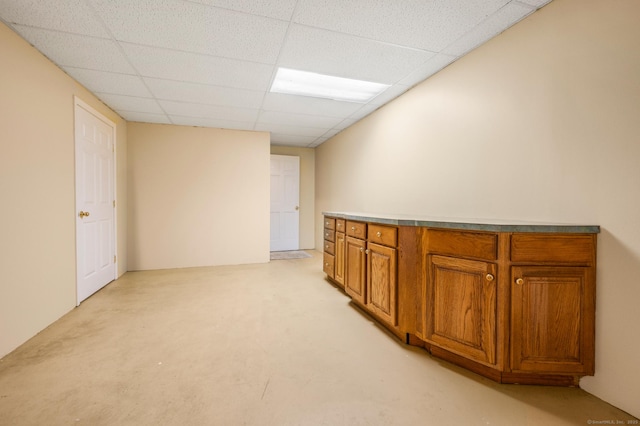 interior space with a paneled ceiling