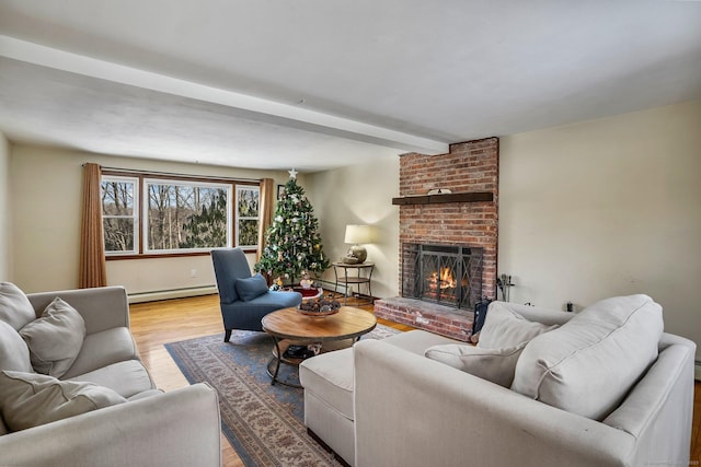 living room with a brick fireplace, baseboard heating, light wood-type flooring, and beam ceiling