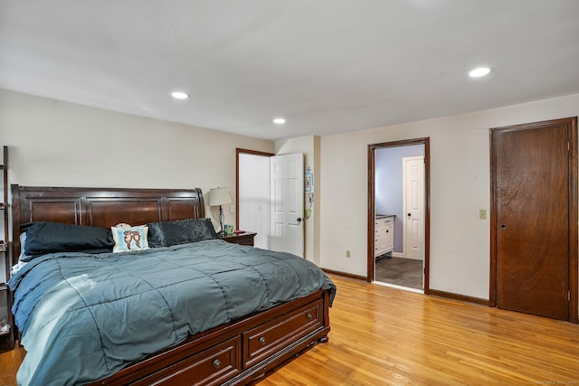 bedroom featuring light hardwood / wood-style floors and ensuite bathroom