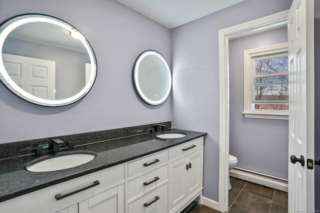 bathroom with toilet, tile patterned flooring, a baseboard radiator, and vanity