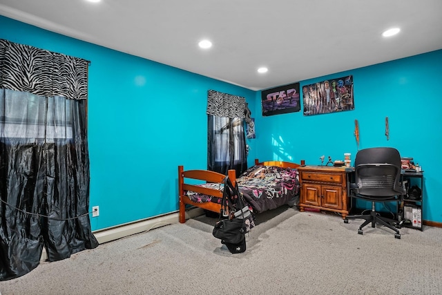 bedroom with baseboard heating and carpet floors