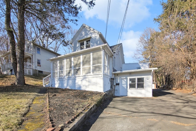 view of front facade with a sunroom